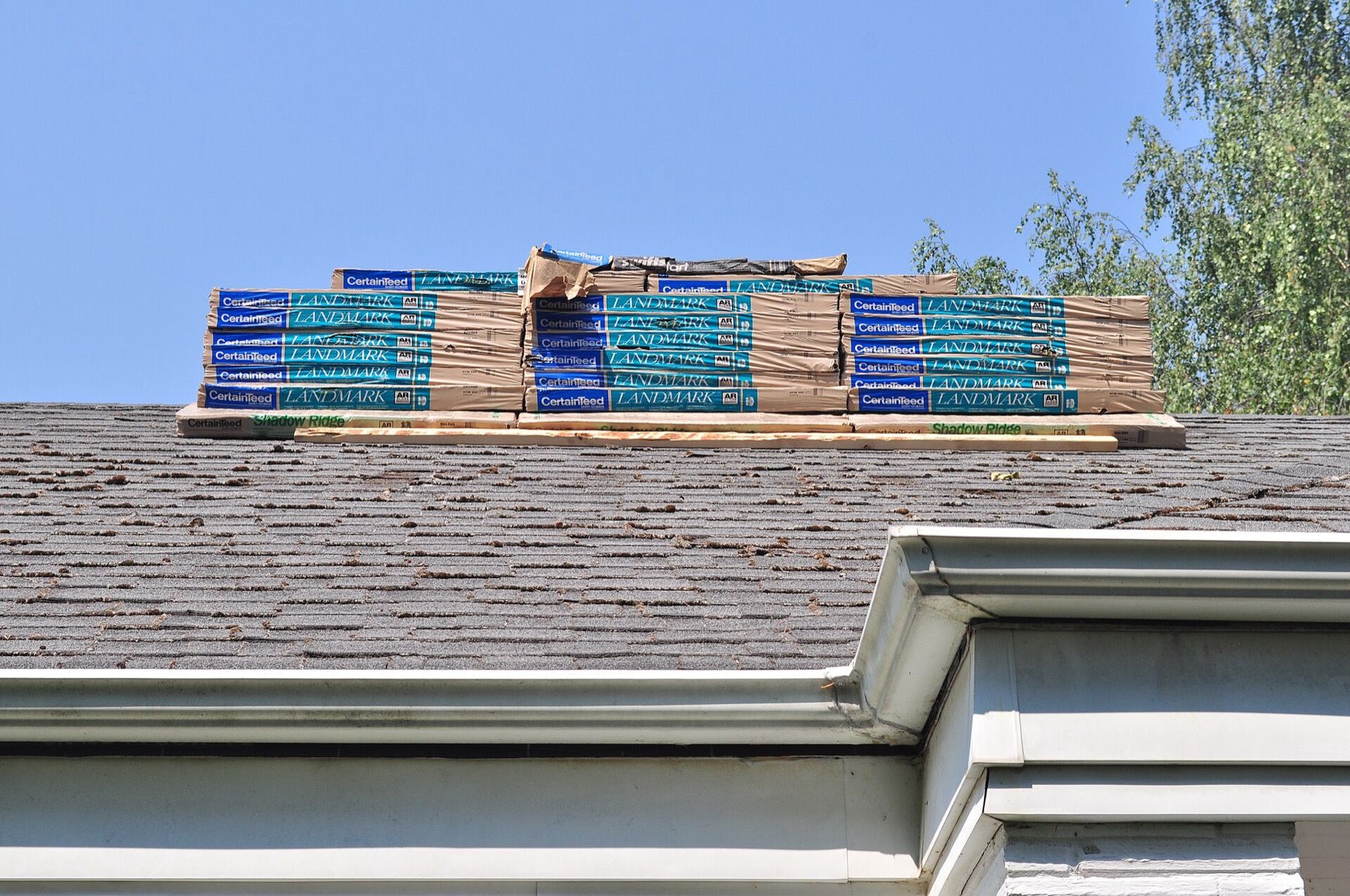 New shingles stacked on a roof ridge